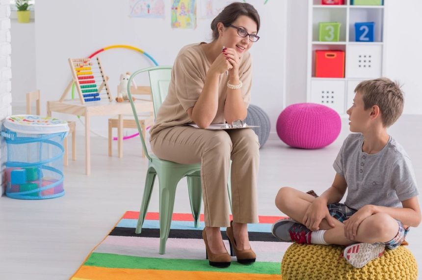 A woman sitting on the ground with another person.